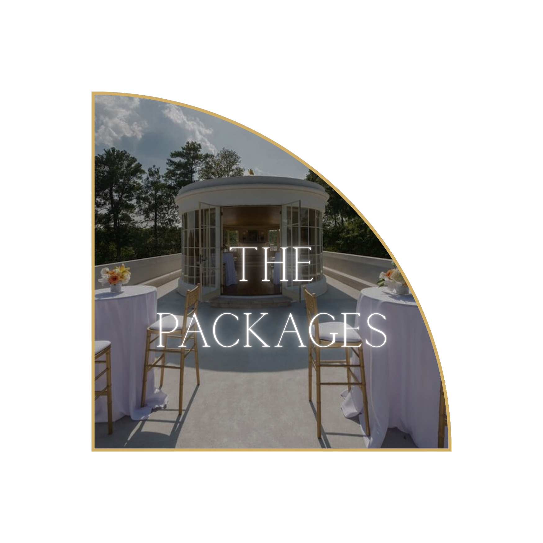 Outdoor event space with round tables covered in white tablecloths, chairs, and small floral centerpieces, set on a rooftop terrace with a white rounded pavilion in the background and surrounded by trees.