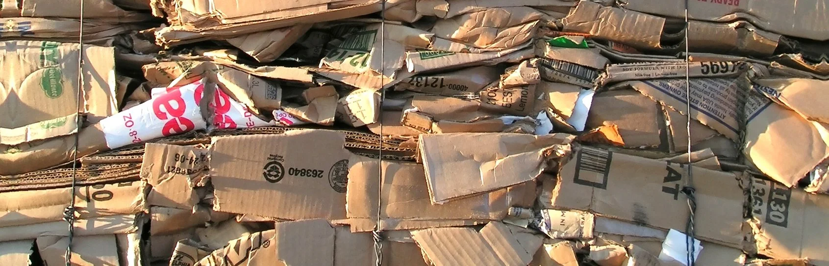 Bundles of crumpled cardboard tied with wire.