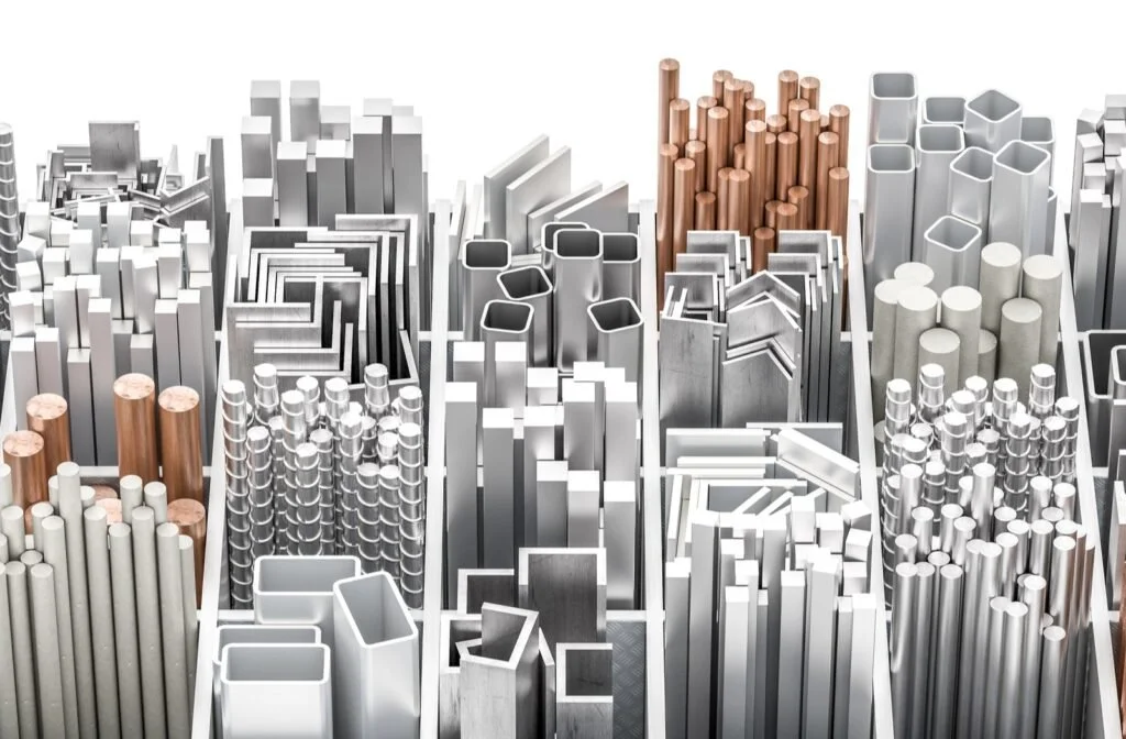 An assortment of metal tubes and pipes of various shapes, sizes, and colors, including silver, white, and copper, arranged in a geometric pattern.