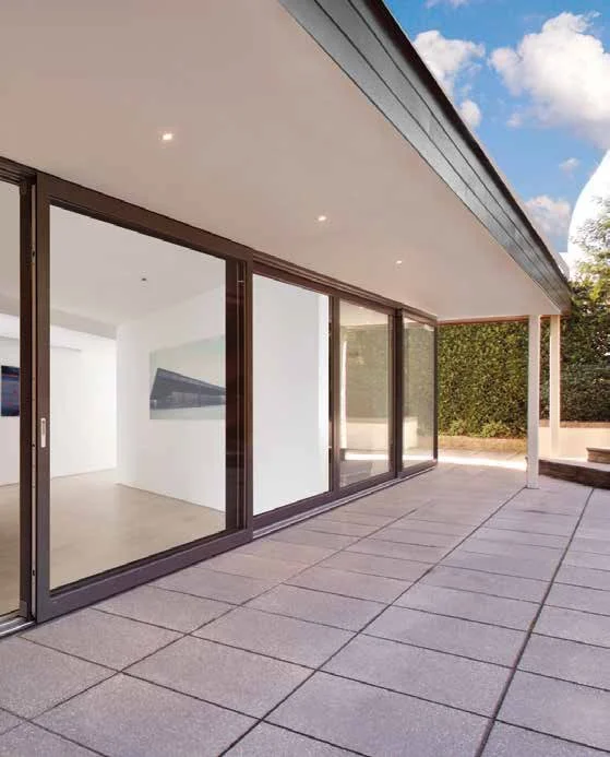 Residential terrace featuring full-height sliding glass panels for panoramic openness.