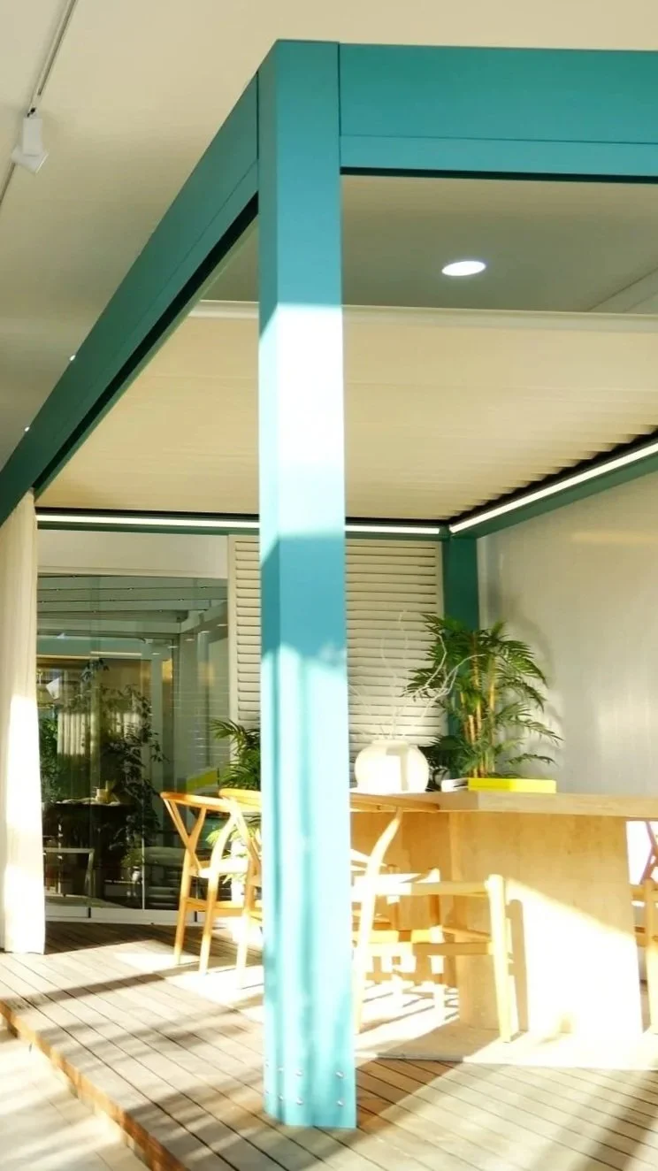 Commercial façade featuring powder-coated motorized screen cassettes matching building color.