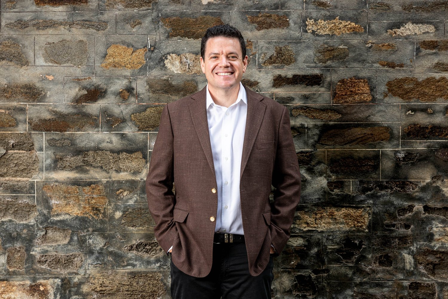 Corporate portrait against a bluestone wall