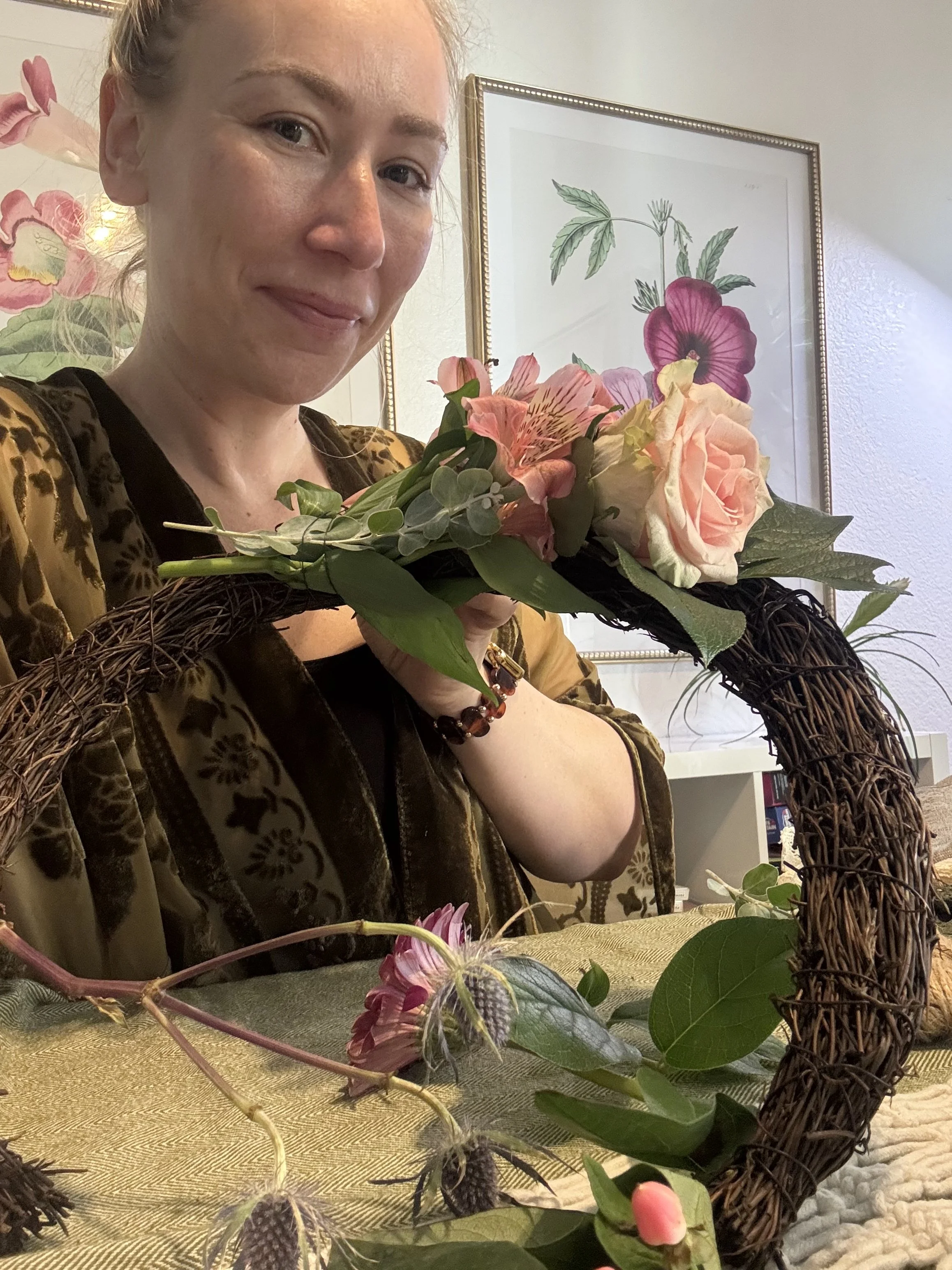 woman holding a crafted yule moon with flowers
