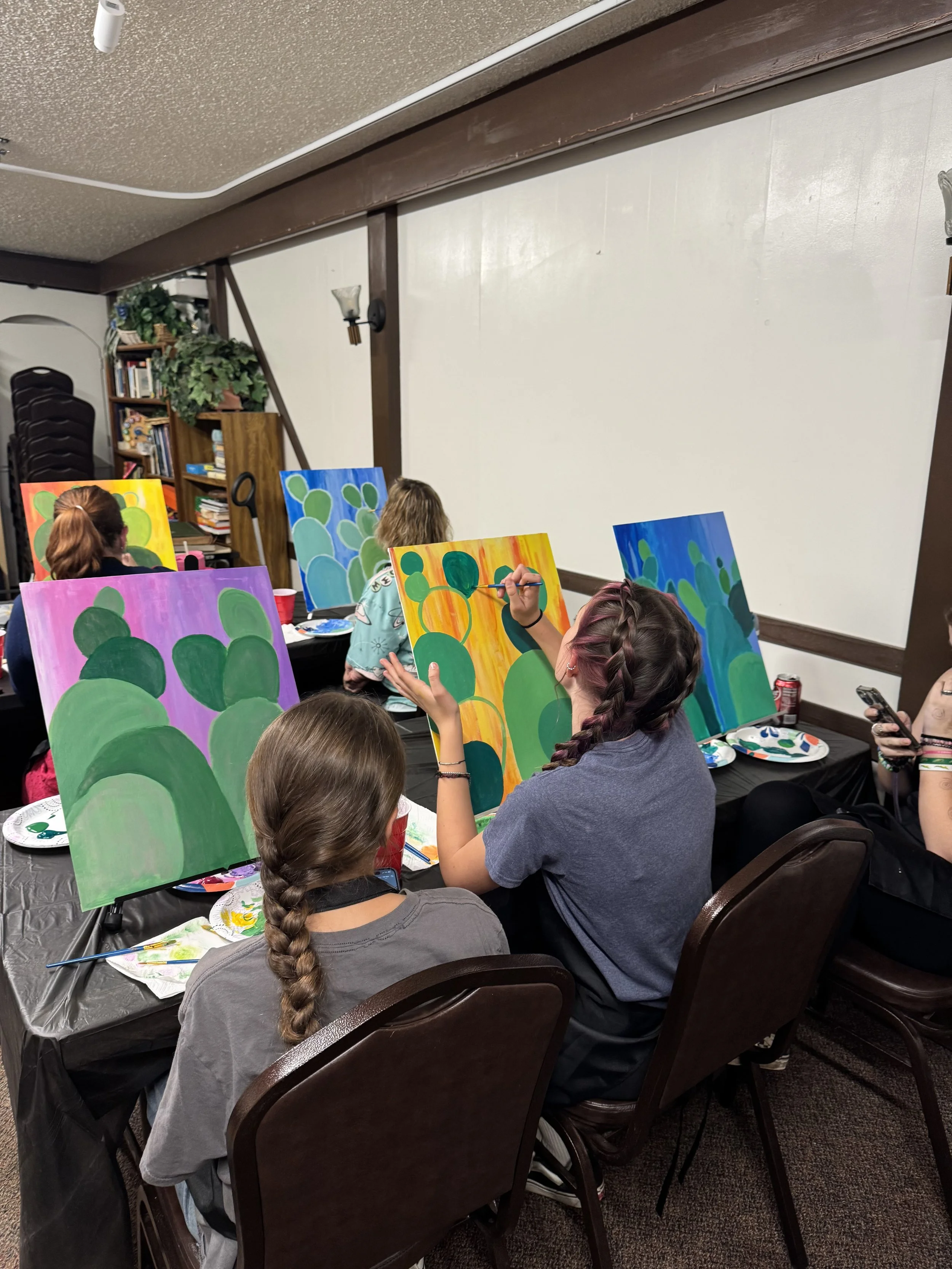 Poeple painting coloful cactus paintings