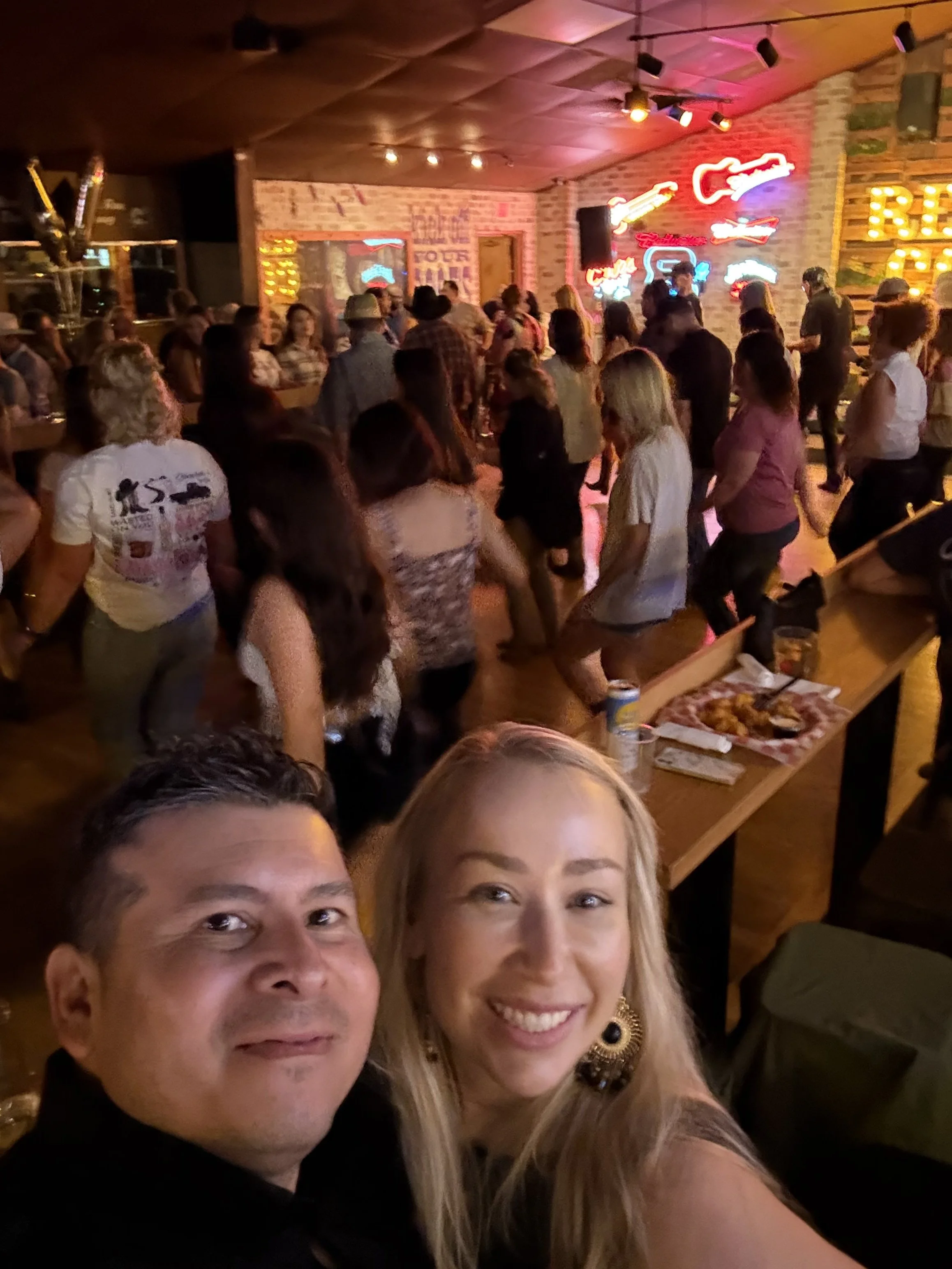 two people taking a selfie in a line dancing bar in east county san diego