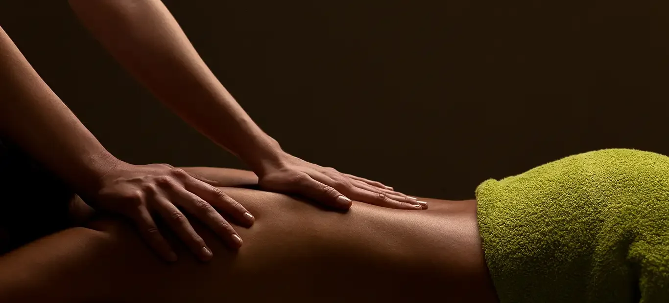 Hands massaging a man's back
