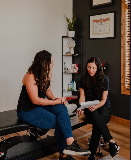 Dr. Joanna Consiglio talking with a patient about their functional medicine protocol, emphasizing individualized care and holistic health support.