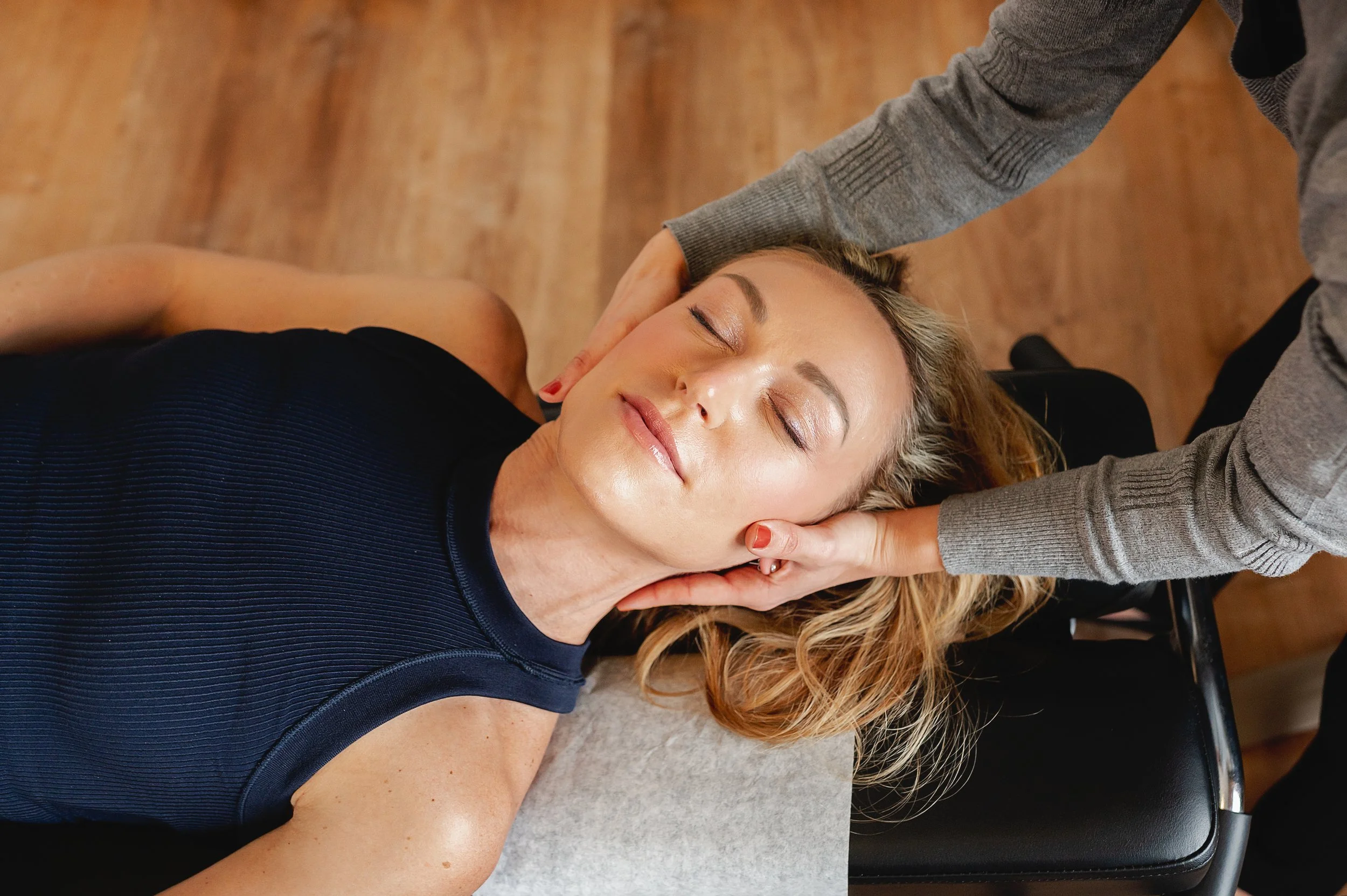 Female patient receiving a gentle neck adjustment from Dr. Joanna Consiglio at Modern Motion Chiropractic in North Royalton, emphasizing safe, evidence-based chiropractic care for pain relief and mobility.