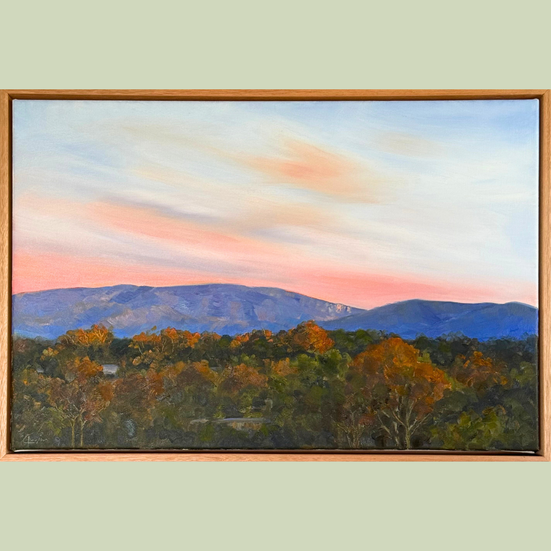 A landscape painting of mountains in the distance with a colorful sky, and a forest with trees displaying autumn colors in the foreground