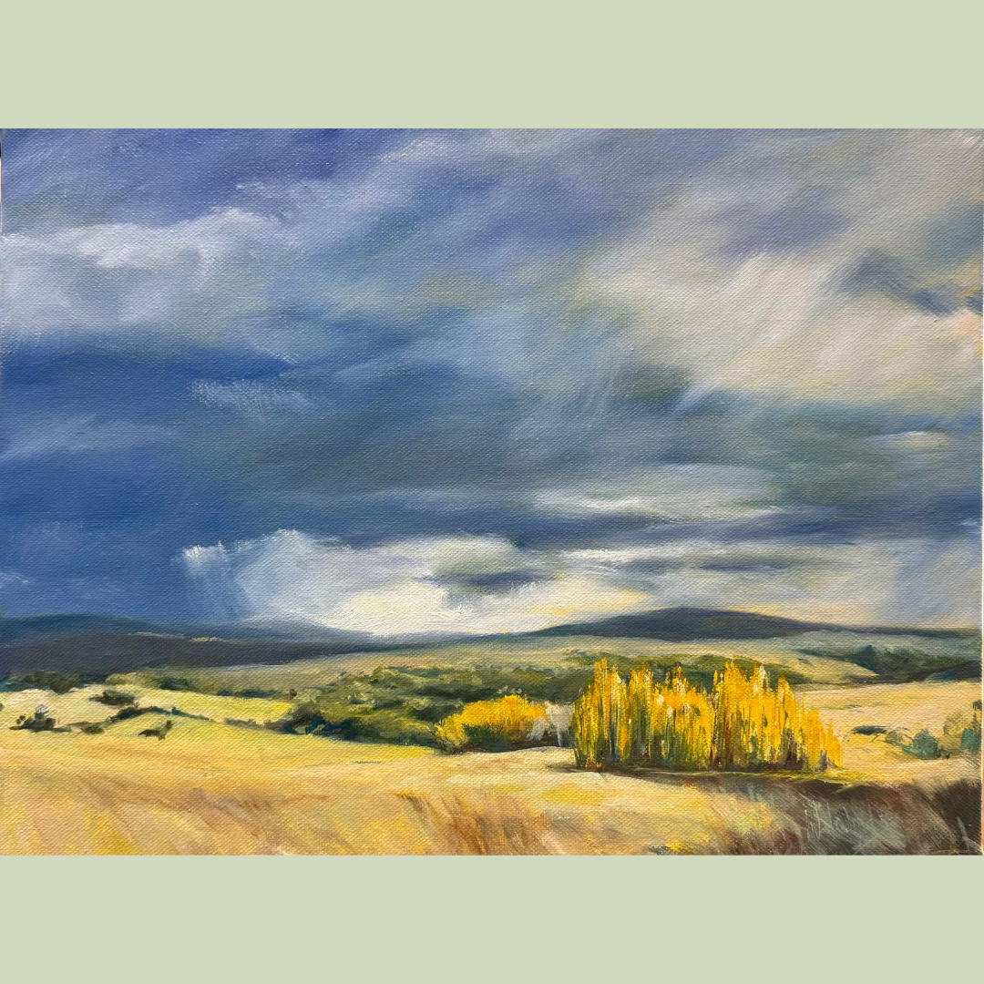 A landscape painting showing a cloudy sky over rolling hills with a cluster of yellow trees in the foreground.