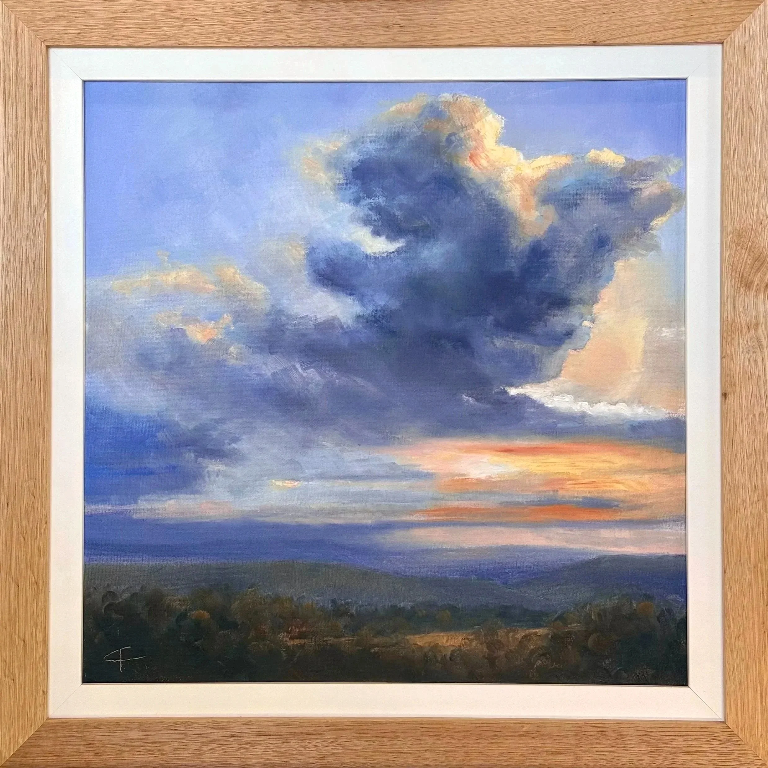 Framed artwork of a storm with dark clouds and sunlight