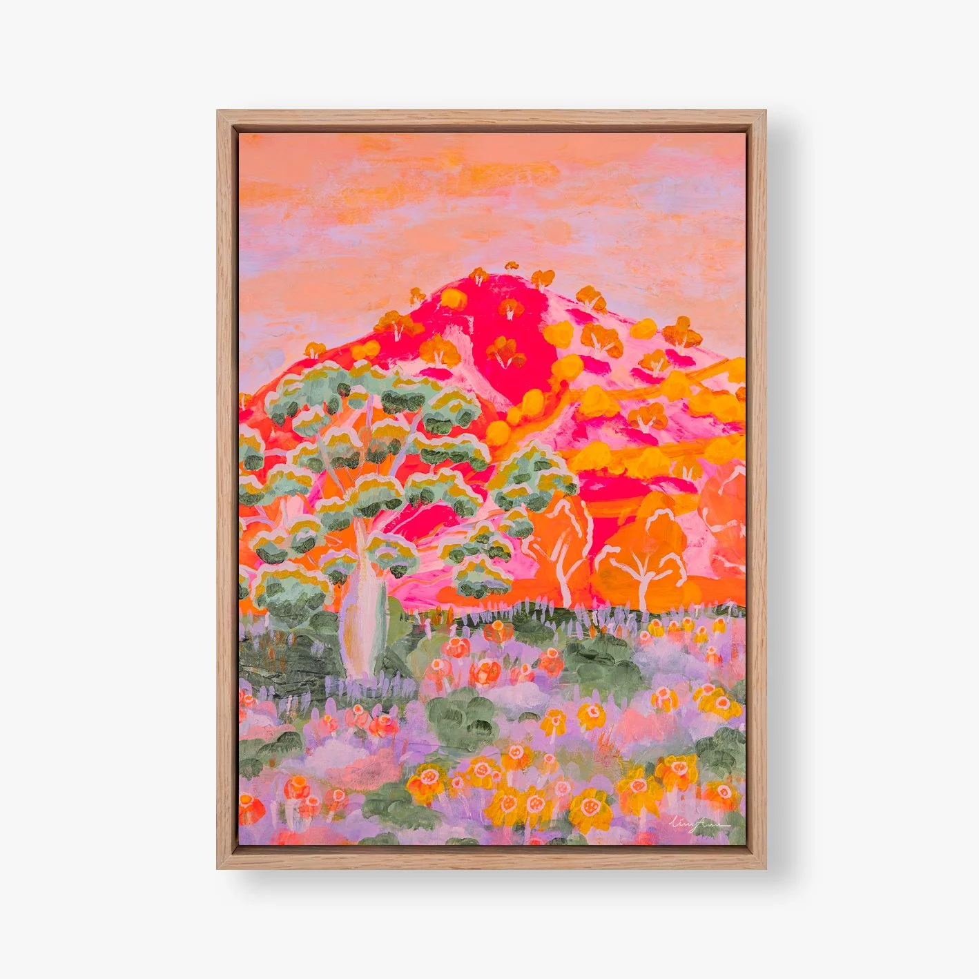 Colorful painting of a landscape with a pink mountain, trees, and flowers in shades of orange, purple, and green in a wooden frame.