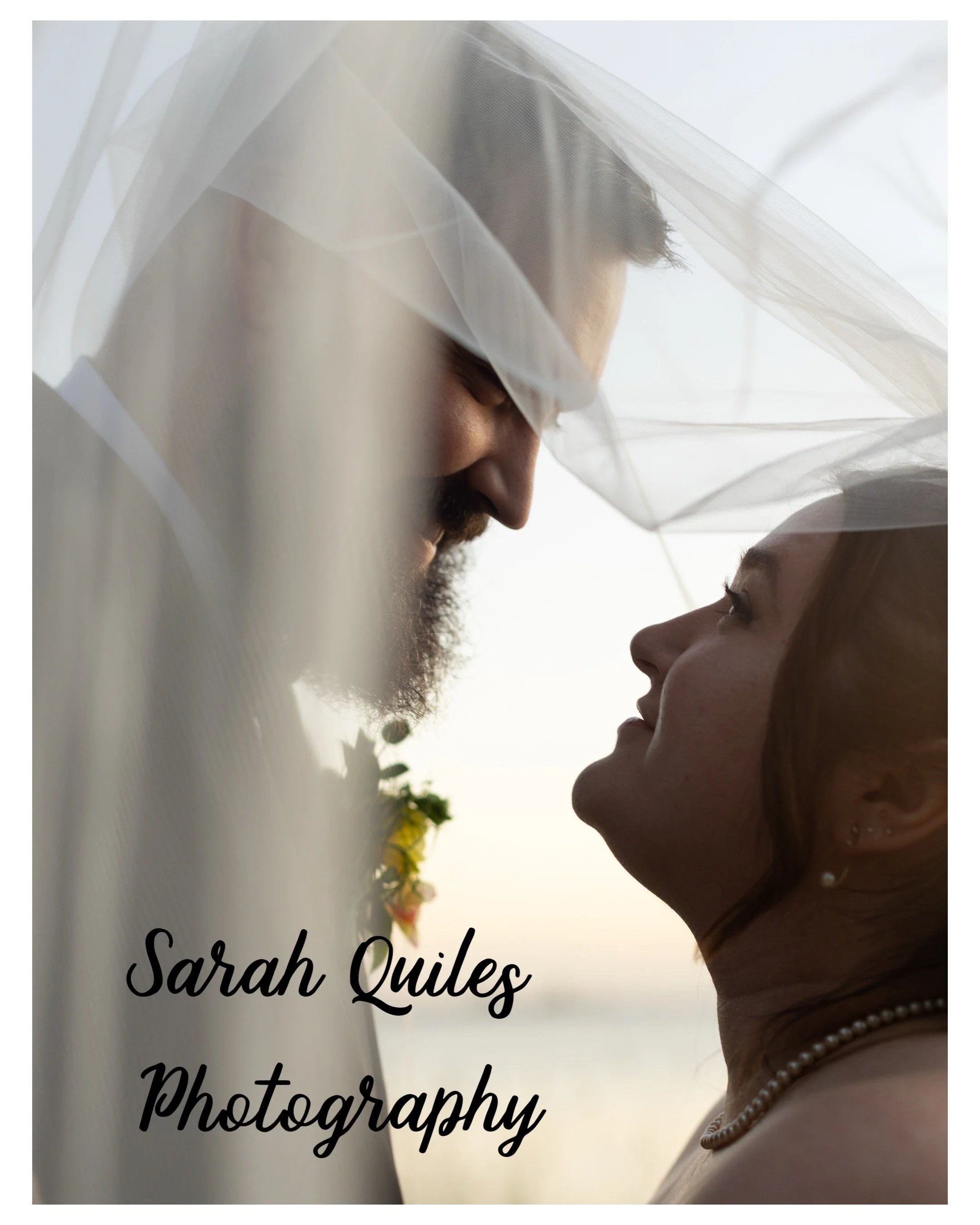 Bride and Groom Portrait with Bride and Groom embracing and looking each other. They are in front of the Chesapeake Bay in Norfolk, Virginia after their wedding at Hermitage Museum and Gardens.