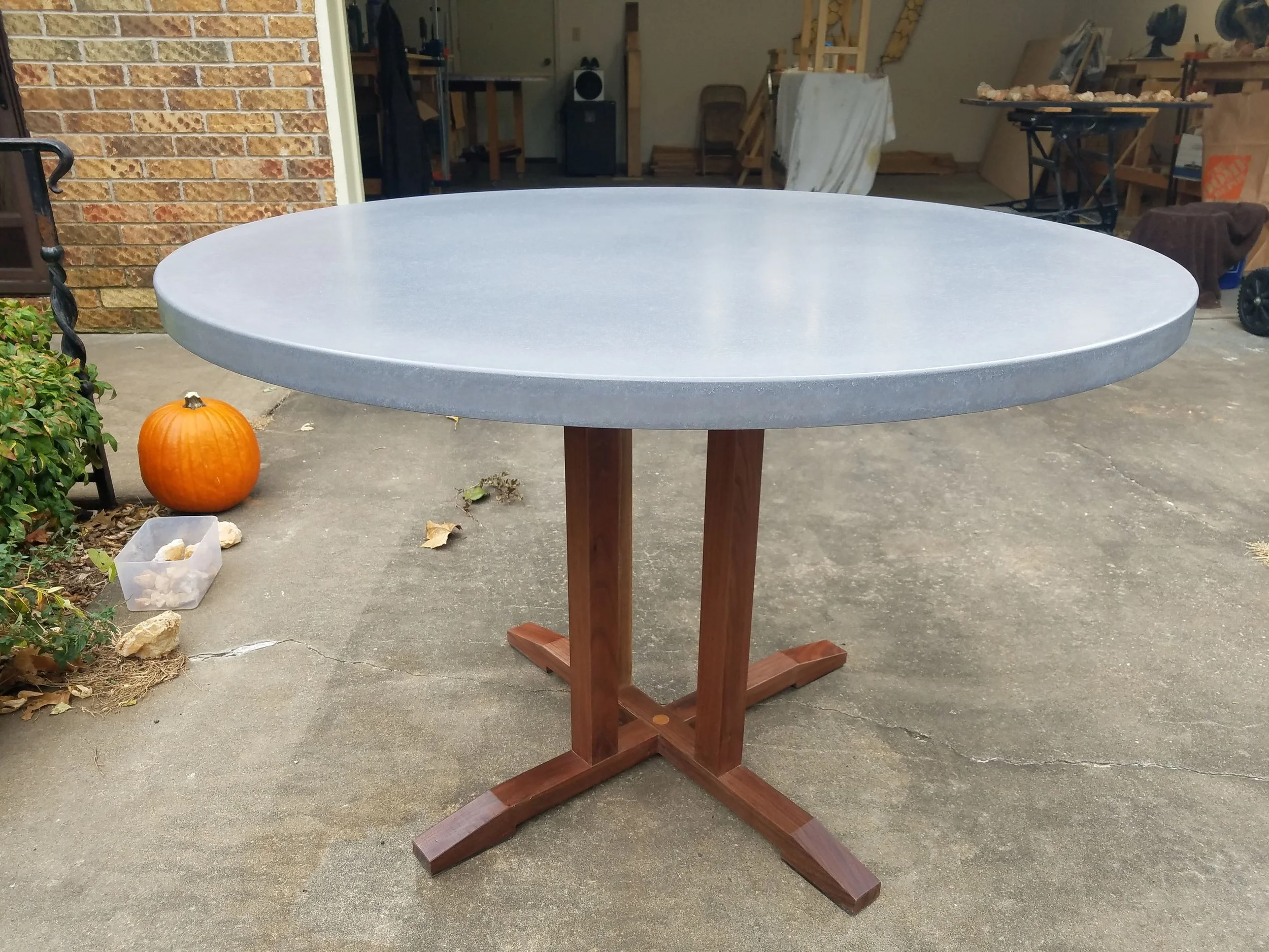 Glass fiber reinforced concrete (GFRC) table top with walnut base