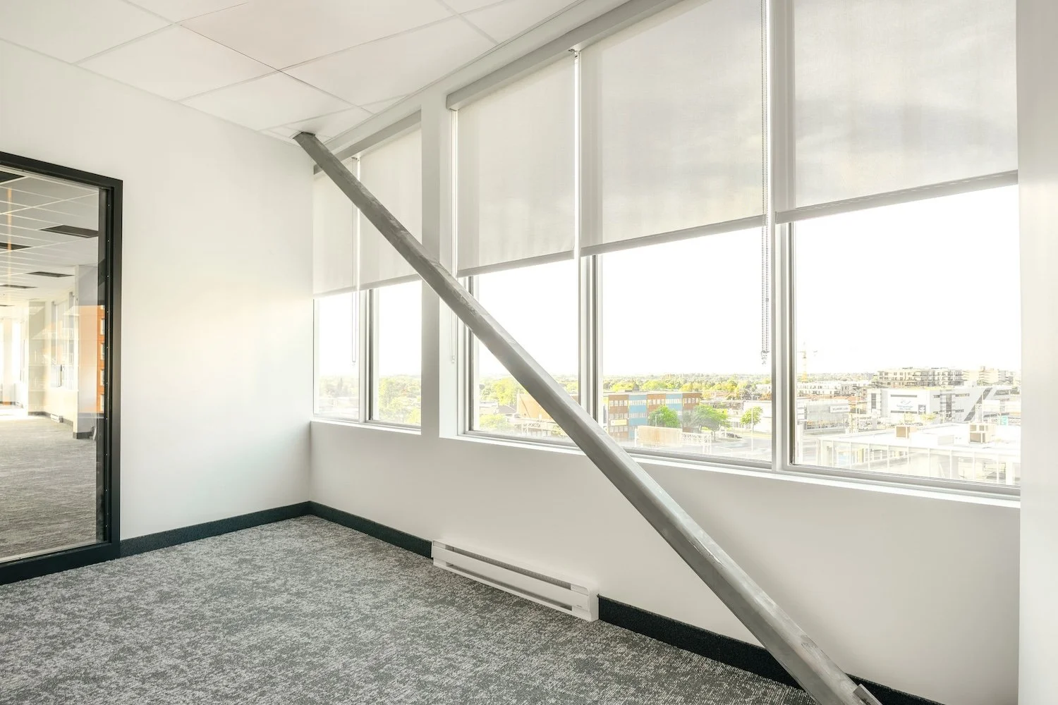 Light-filtering roller shades on tall stairwell windows