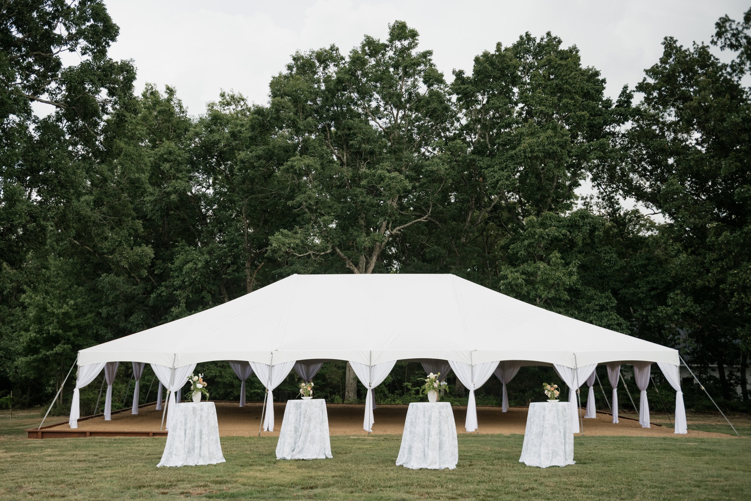 The Oak Ridge Homestead, a new wedding and event venue near Charlotte, NC in Stanly County with large white event tent, twinkle lights. English, European garden. Cocktail hour.