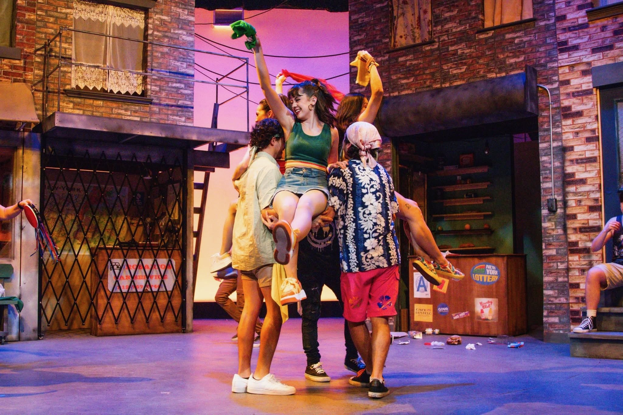 Gabriela Ayala Yarbrough smiling and throwing scarf in the air while in a lift, dancing, smiling