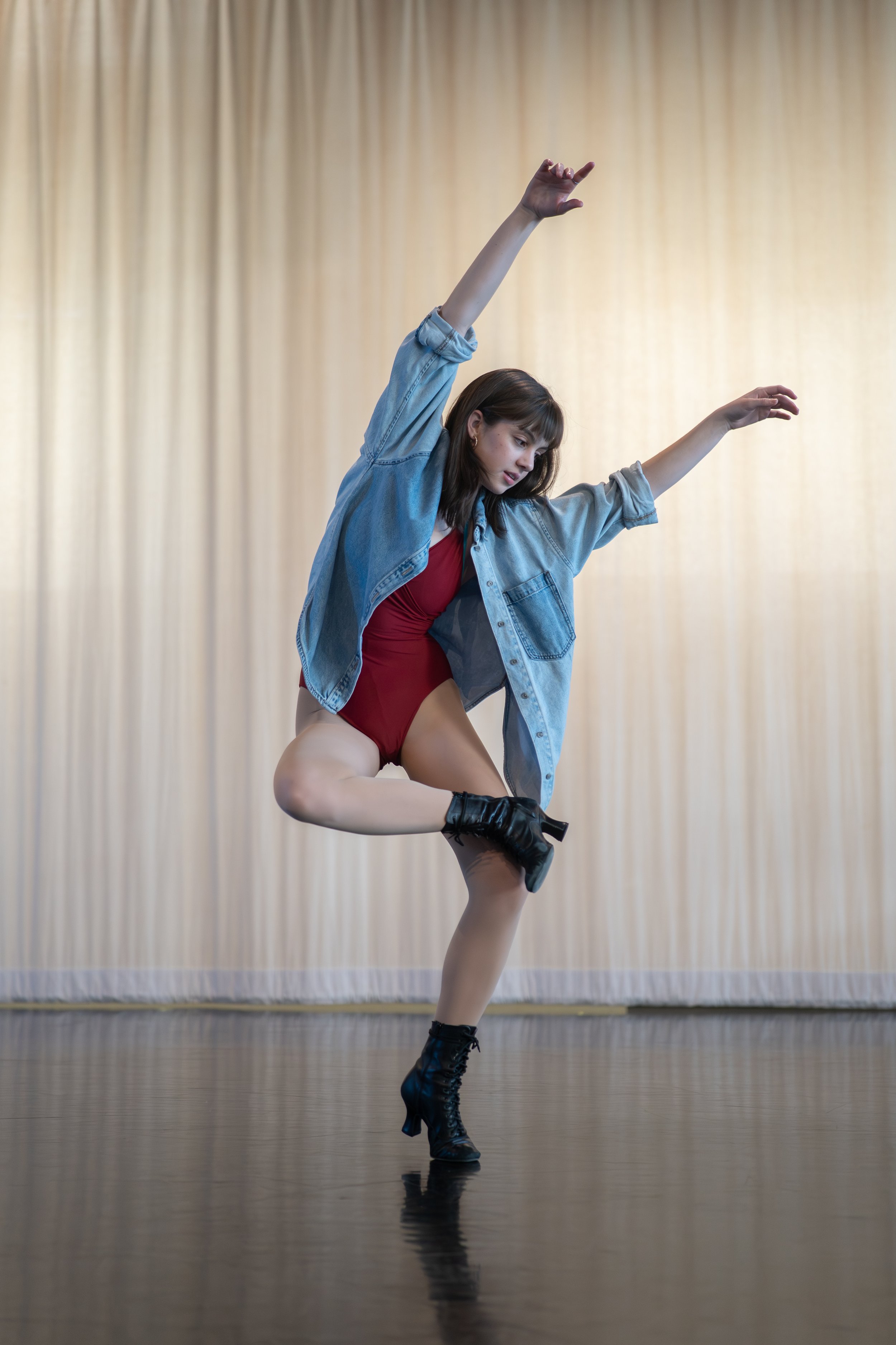 Gabriela Ayala Yarbrough dancing in a red leotard with a denim shirt and black LaDucas