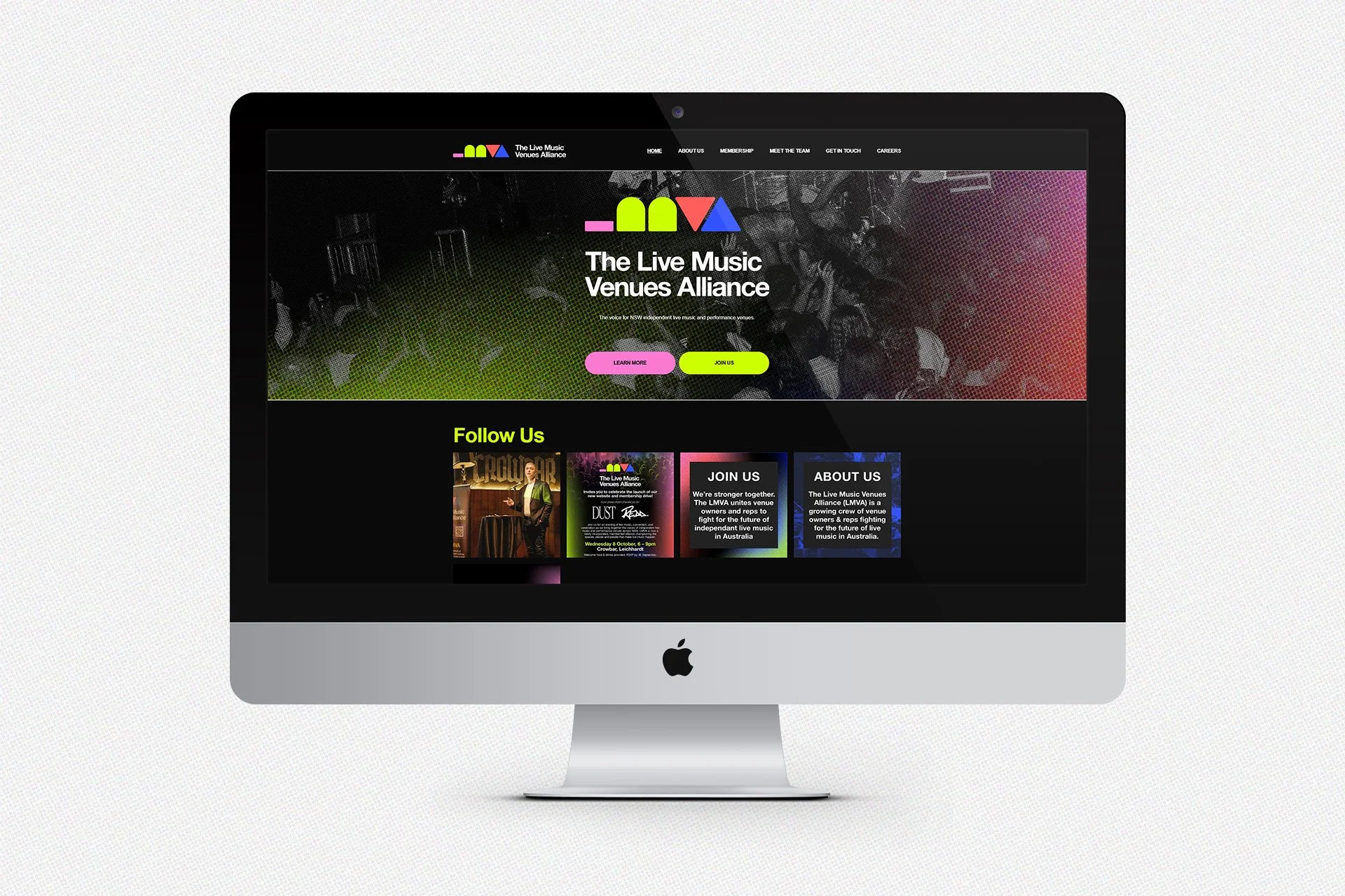 iMac displaying the website for The Live Music Venues Alliance, with a dark background, colorful logo at the top, two call-to-action buttons, and a section with images and texts about the organization.