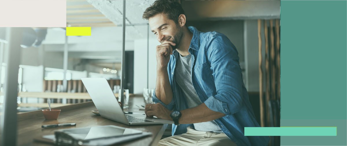 A man sitting at a desk with a laptop, working on his business.