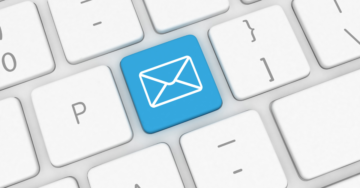 Close-up of a computer keyboard with a blue key featuring a white envelope icon, representing email or messaging.