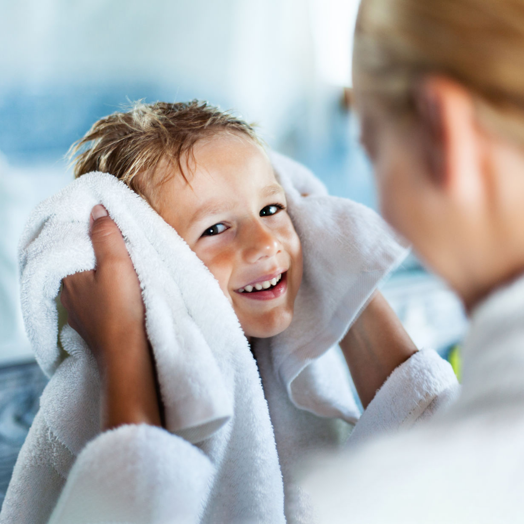 Child wrapped in towel after enjoying warm bath