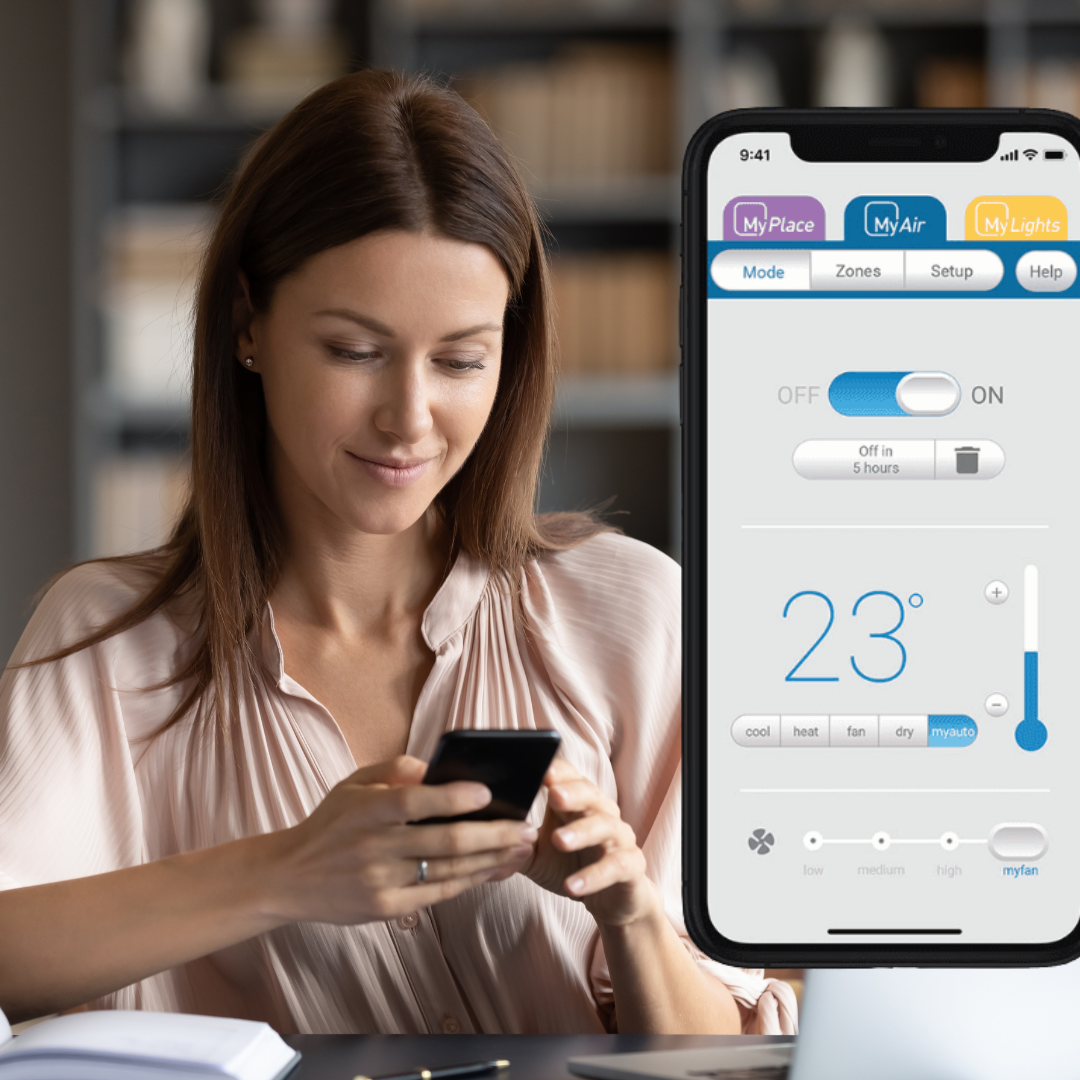 Woman using smartphone app to control home heating and cooling system remotely