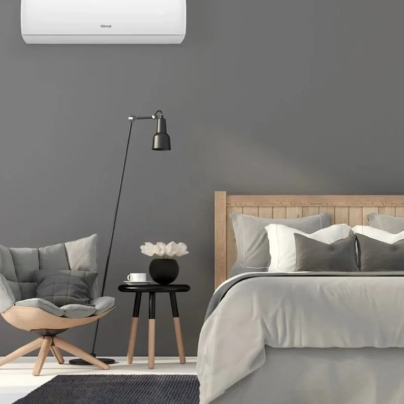 Wall-mounted split system air conditioner in modern bedroom