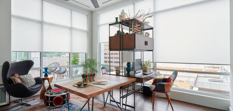 Bright modern office with large windows, contemporary furniture, and decorative items.