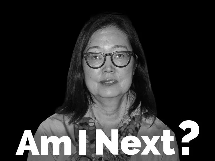 A black and white portrait of a woman wearing glasses with text overlay that says 'Am I Next?'