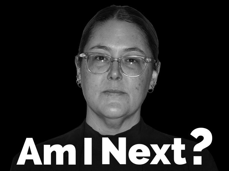 Black and white portrait of a woman with glasses looking directly at the camera, with the text "Am I Next?" at the bottom.