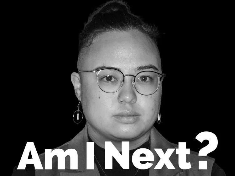 Black and white photo of a person with glasses and earrings, with text 'Am I Next?' at the bottom.