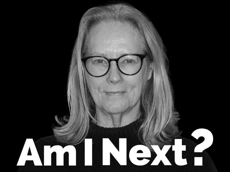 Black and white portrait of a woman with shoulder-length hair and glasses, looking directly at the camera, with the text 'Am I Next?' overlaid.