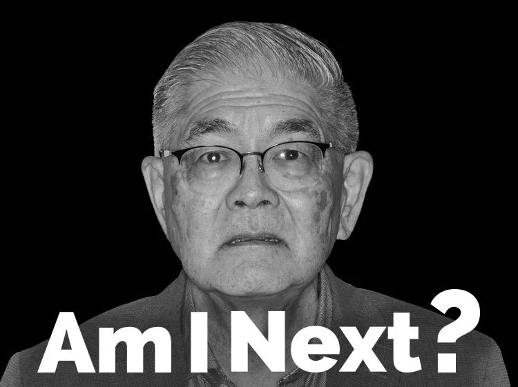 Black-and-white portrait of an elderly man with glasses, looking surprised or confused, with the text 'Am I Next?' overlaid.