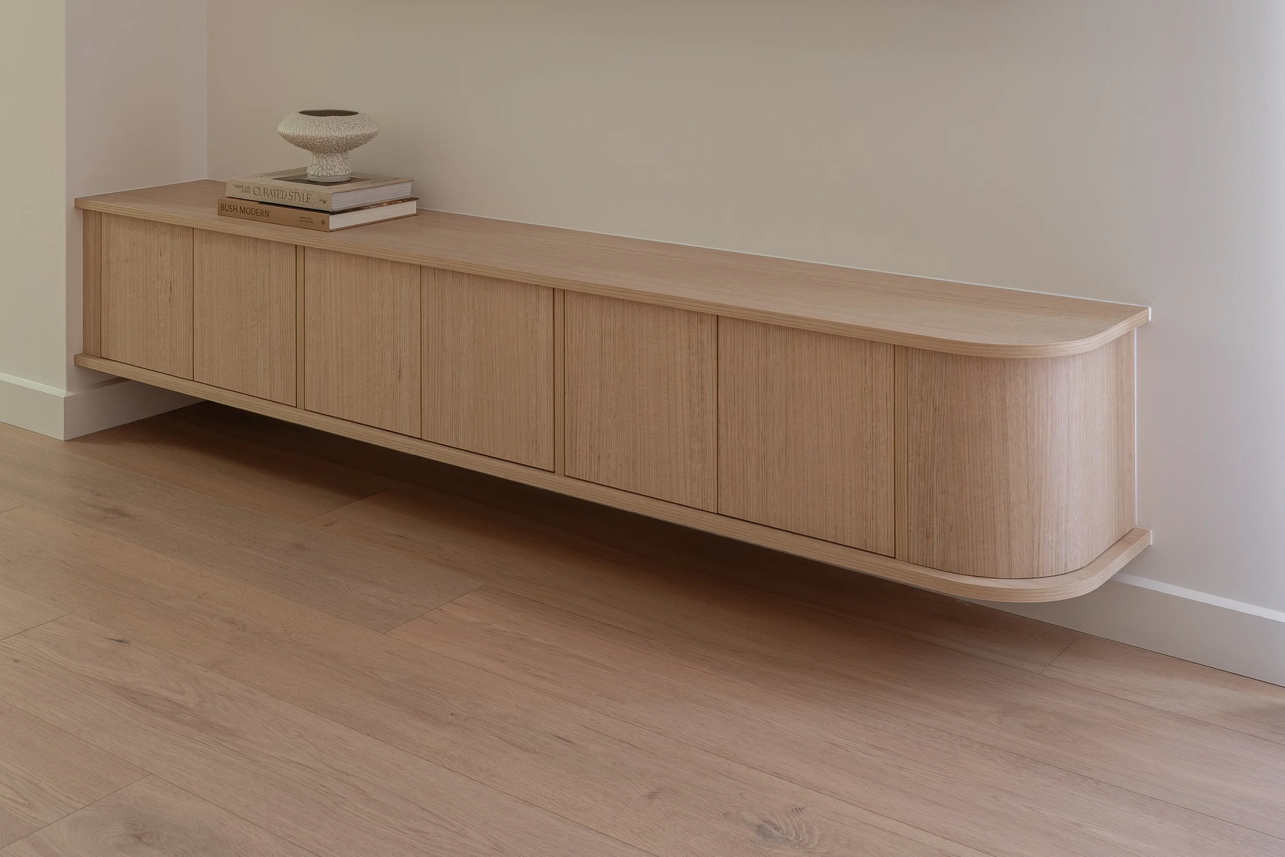 Timbergrain entertainment unit with curved end. 