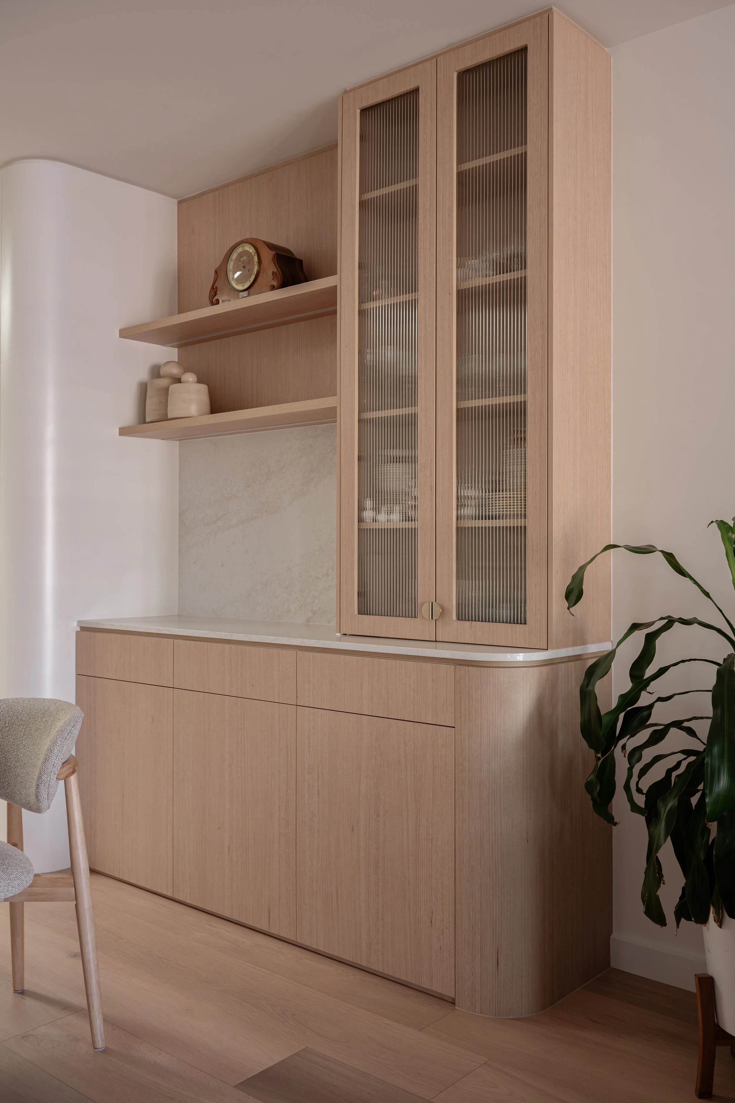 Timbergrain cabinetry featuring open shelving, and fluted glass feature doors. 