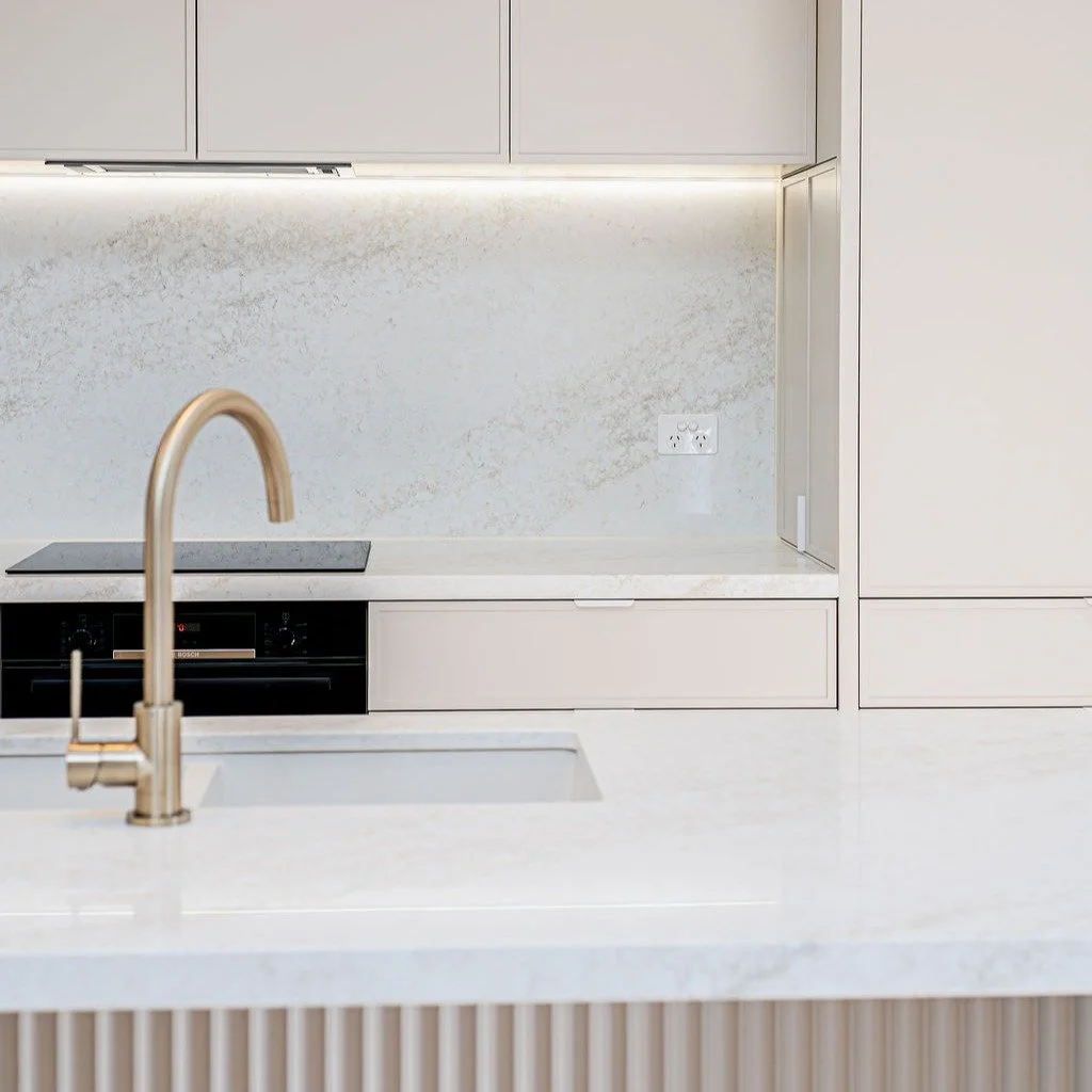 Soft neutrals, clean lines, and a touch of gold ✨

This kitchen is all about understated elegance &mdash; where modern design meets warm, everyday luxury. From the fluted island detail to the seamless cabinetry, every element works in quiet harmony.
