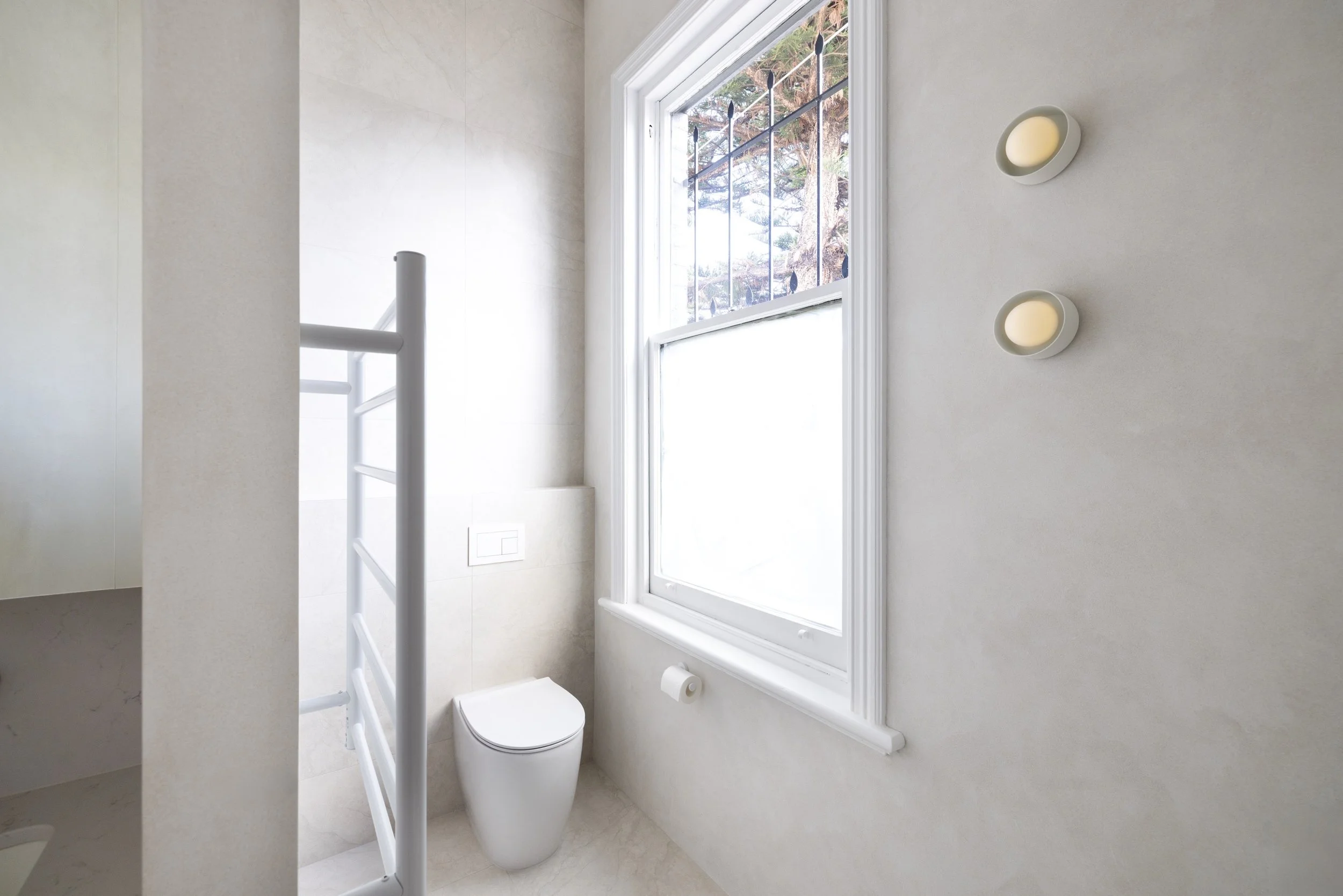 White bathroom with texture wall finish 