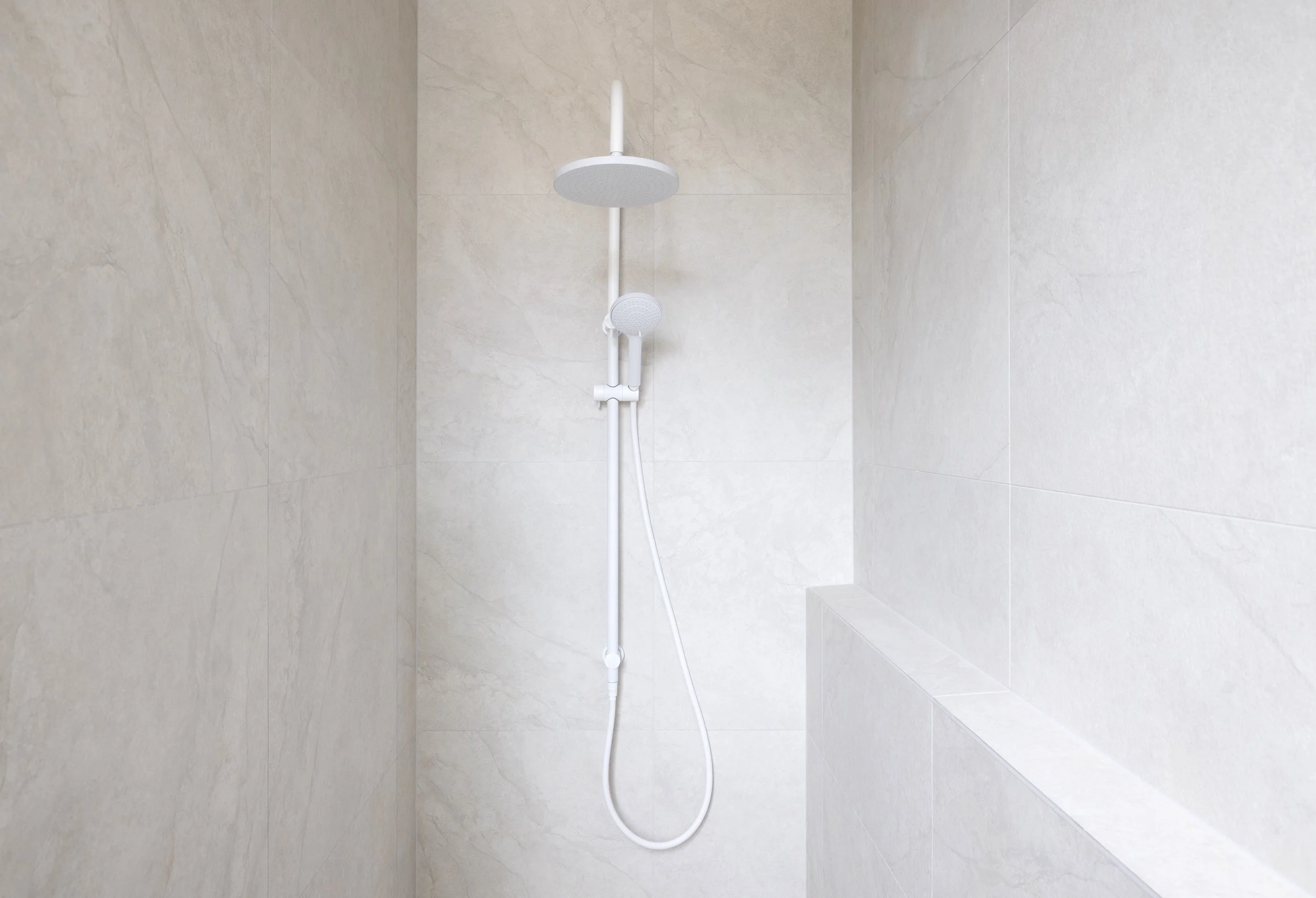 White bathroom with texture wall finish and with white shower