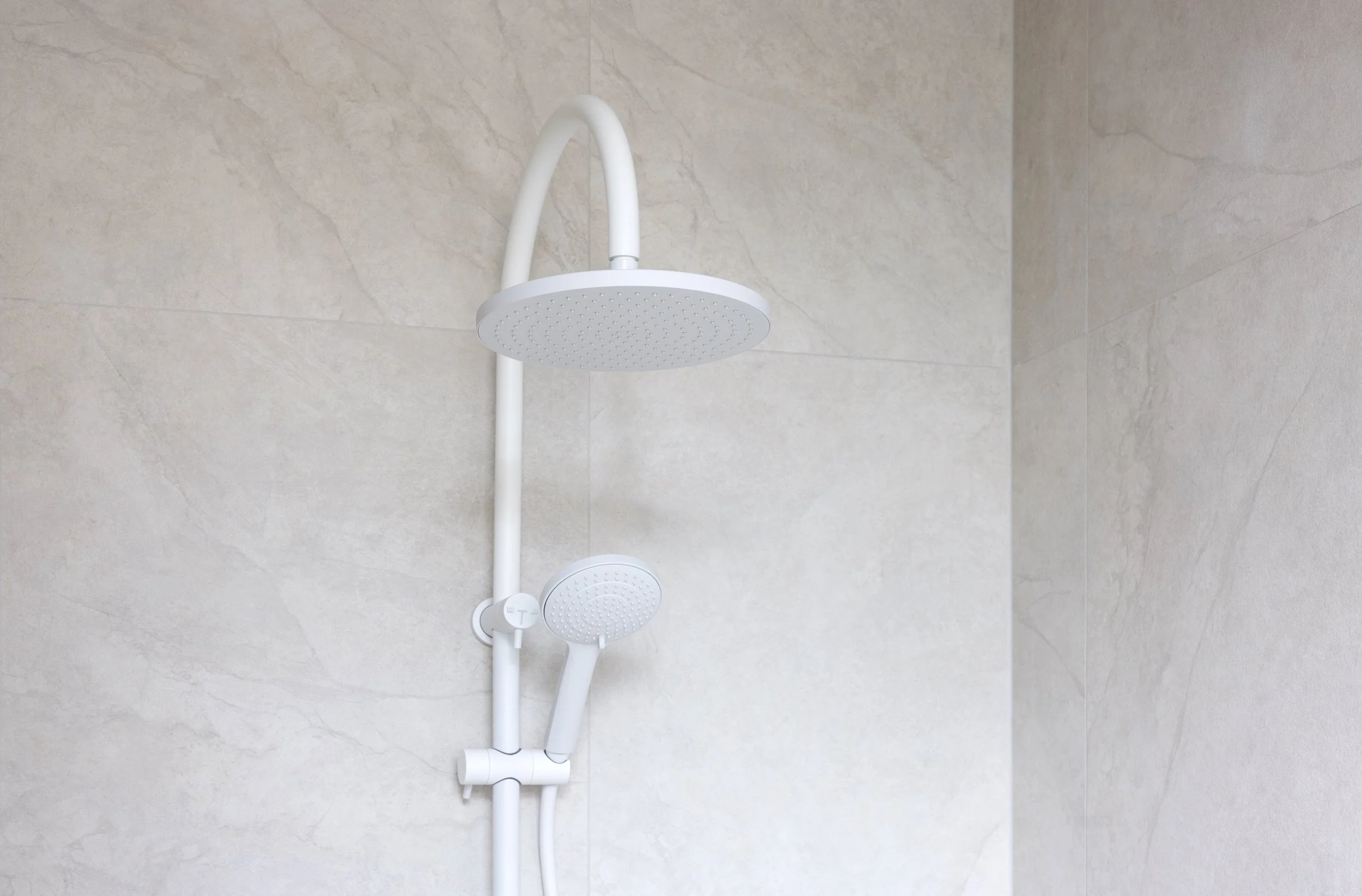 White bathroom with texture wall finish and with white shower