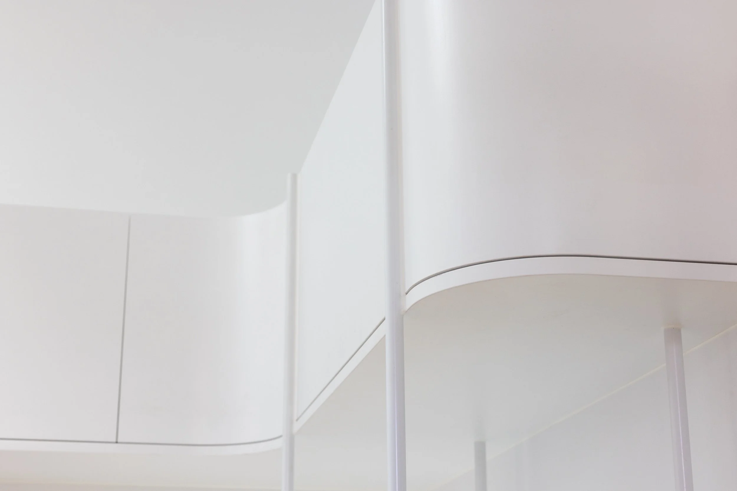 White entertainment unit with curves and open shelving