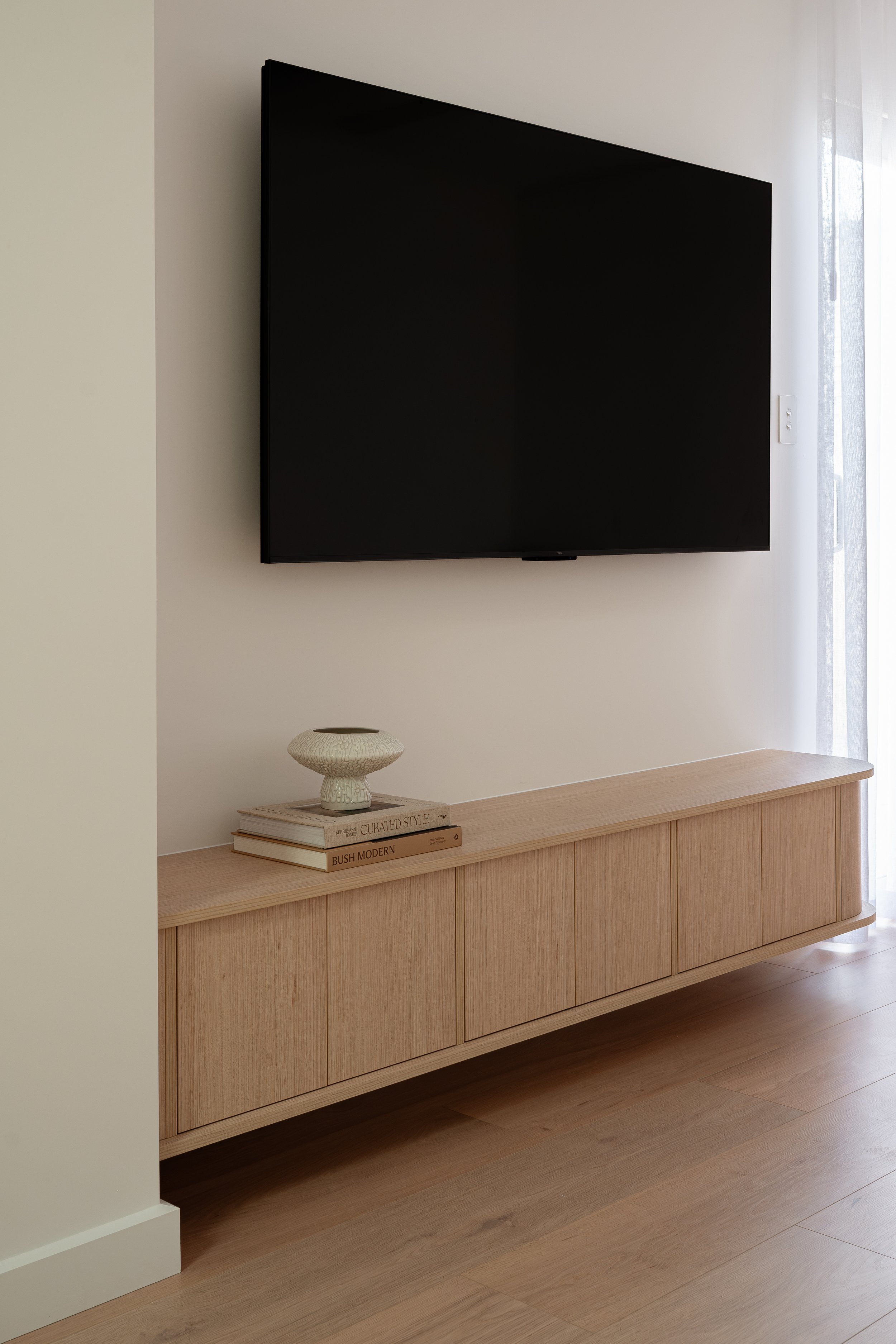 Enterainment unit with TV in light timbergrain. 