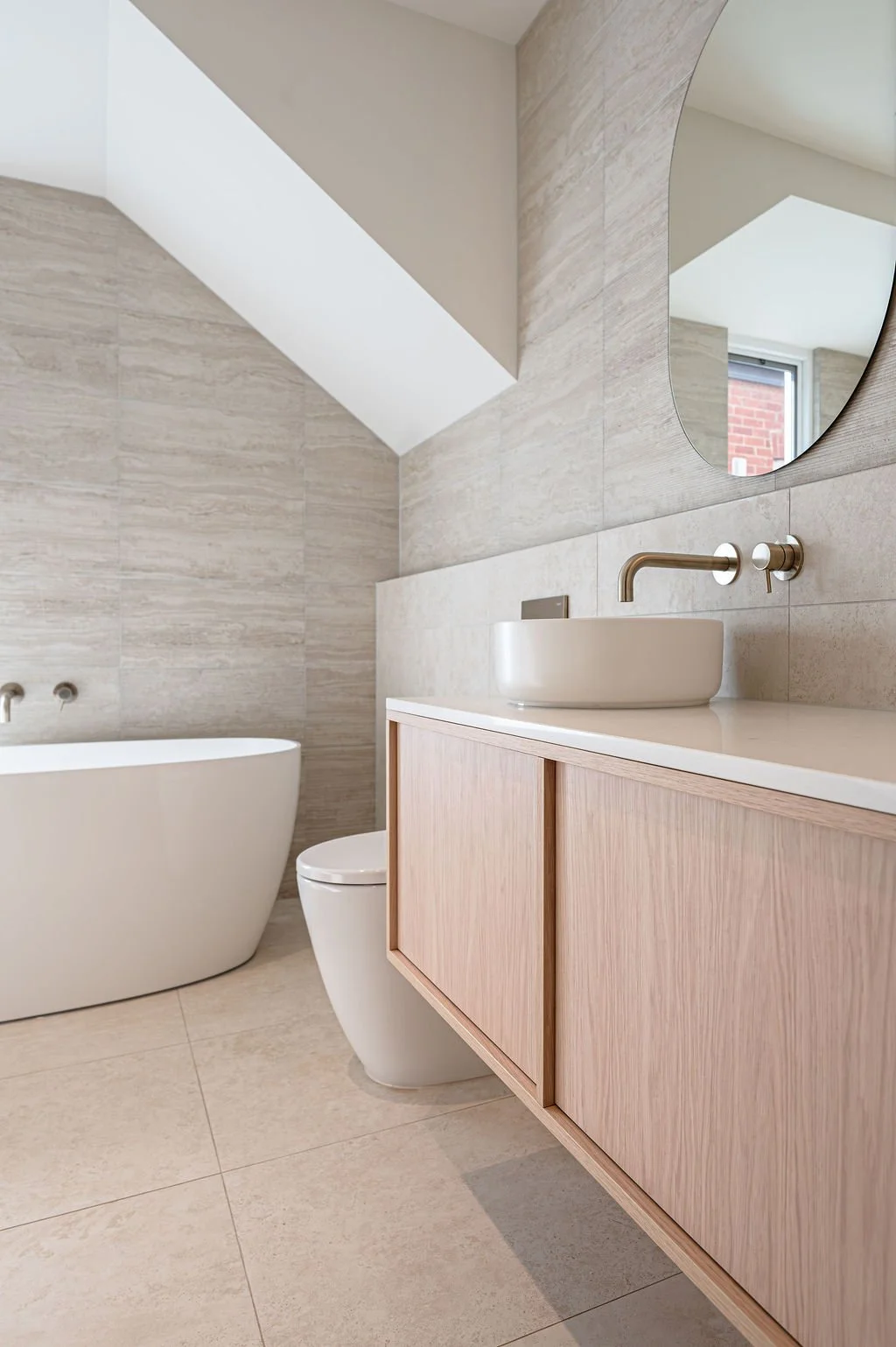 Floating timbergrain vanity with stone benchtop in a neutral bathroom