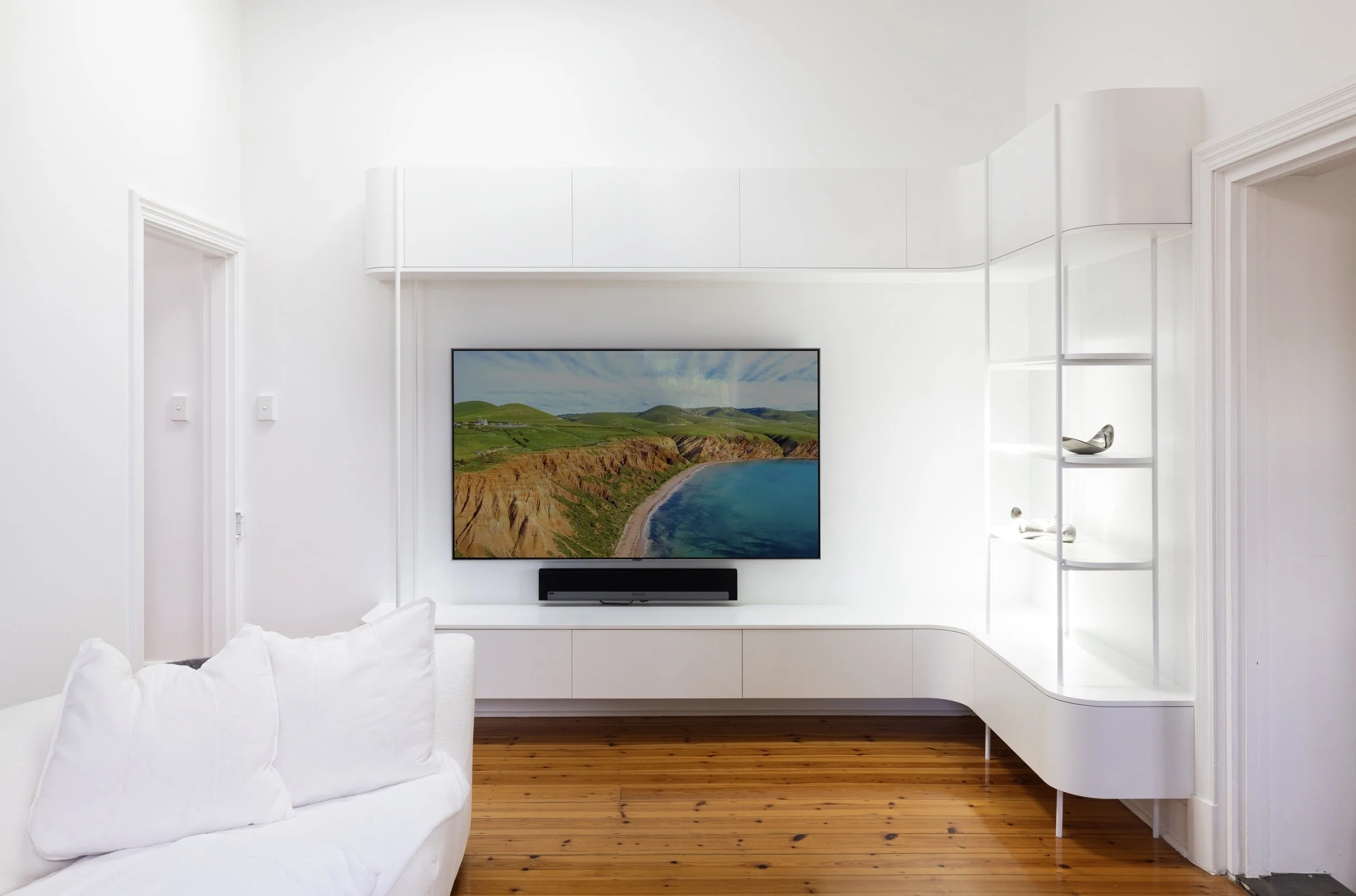 White entertainment unit with curves and open shelving
