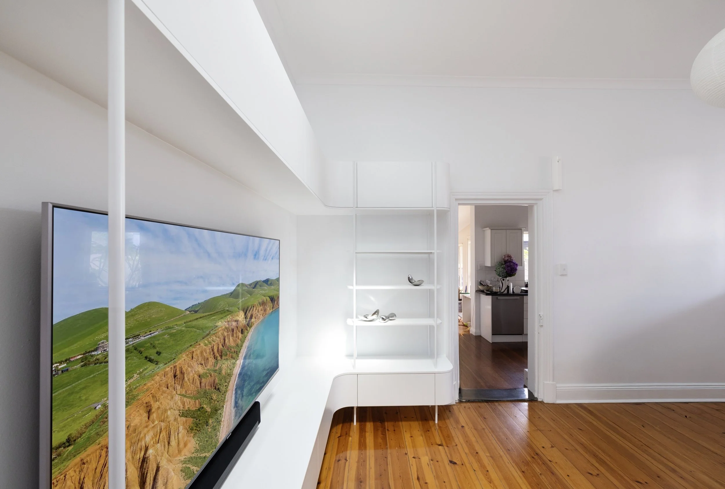 White entertainment unit with curves and open shelving