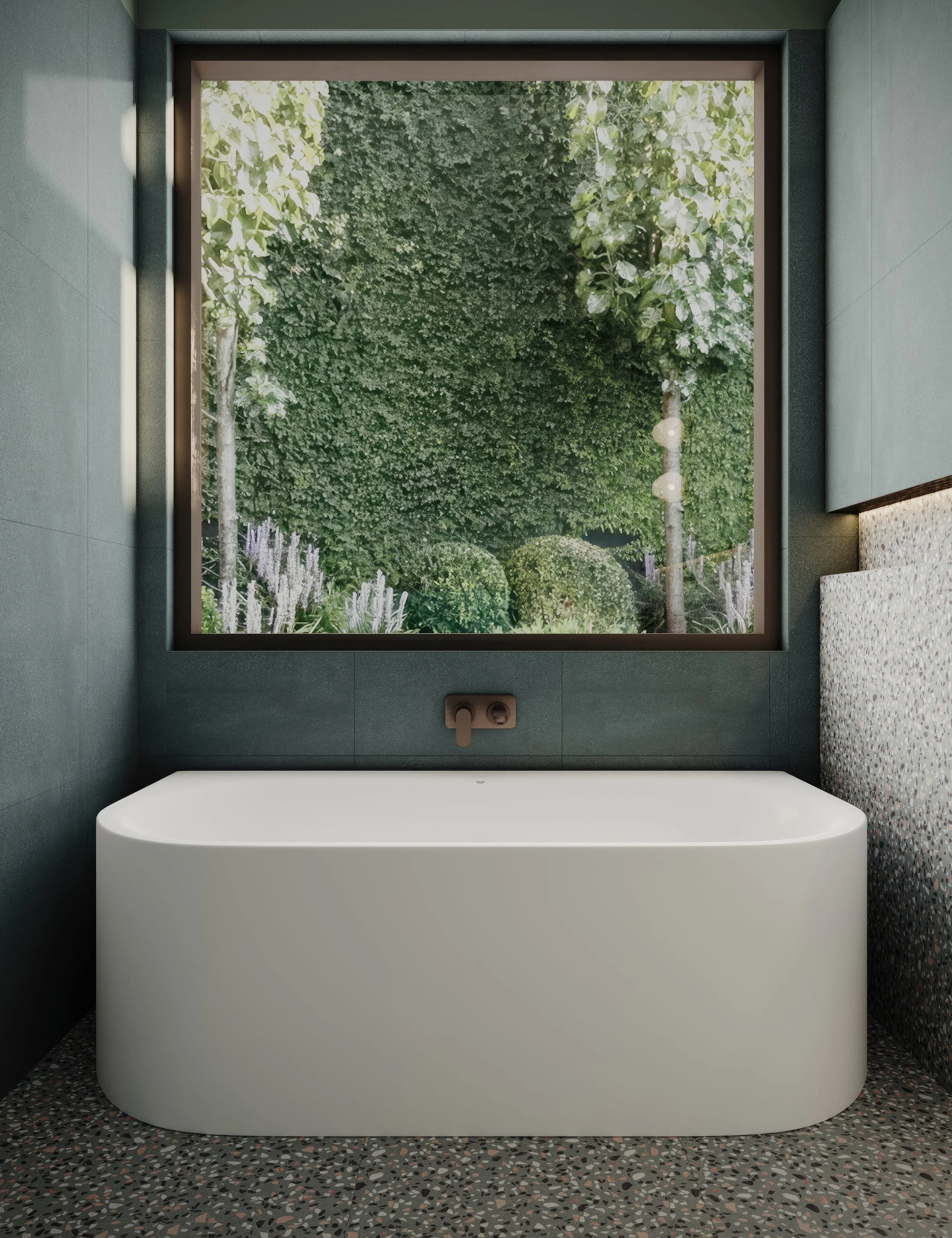 Modern green bathroom designed by Bethany Jane Interior Design with a freestanding white bathtub and bronze tapwear beneath a large window showing green outdoor foliage.