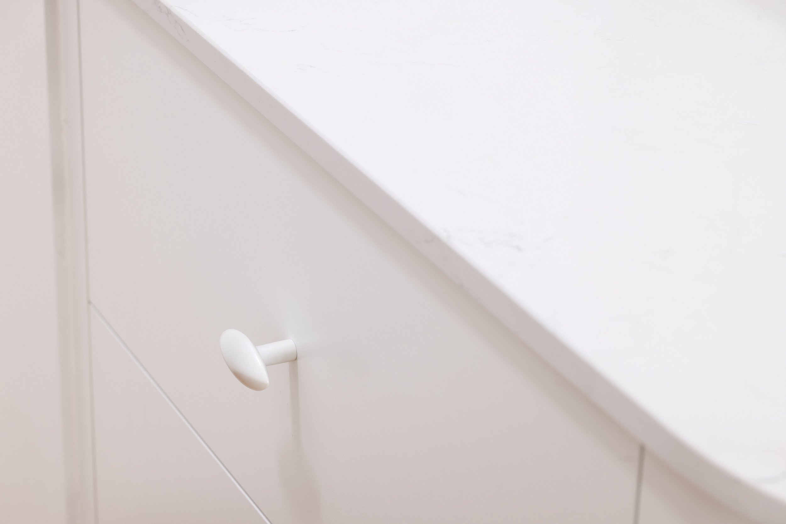 White cabinetry drawer with white handle