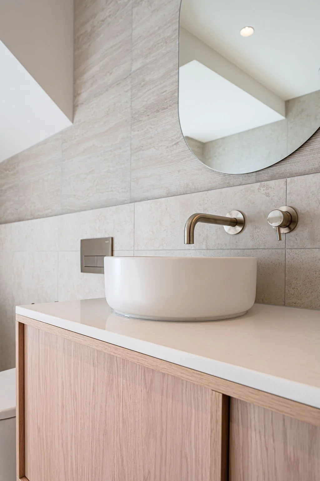 Floating timbergrain vanity with stone benchtop in a neutral bathroom