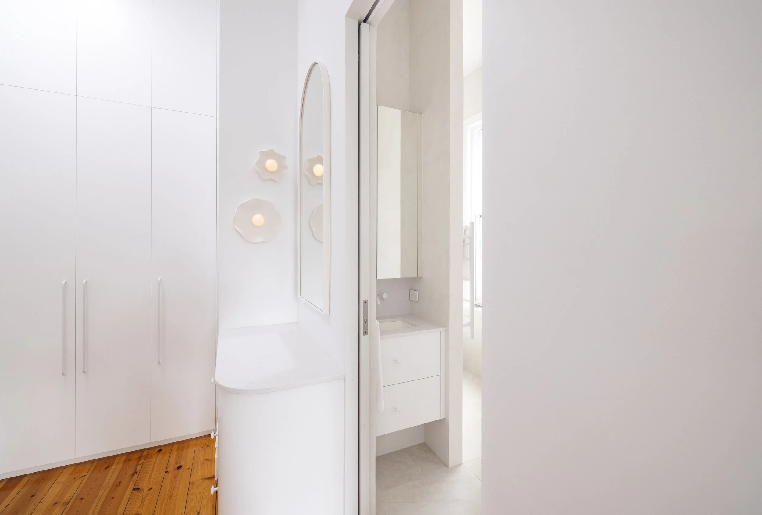 White bathroom with curved vanity