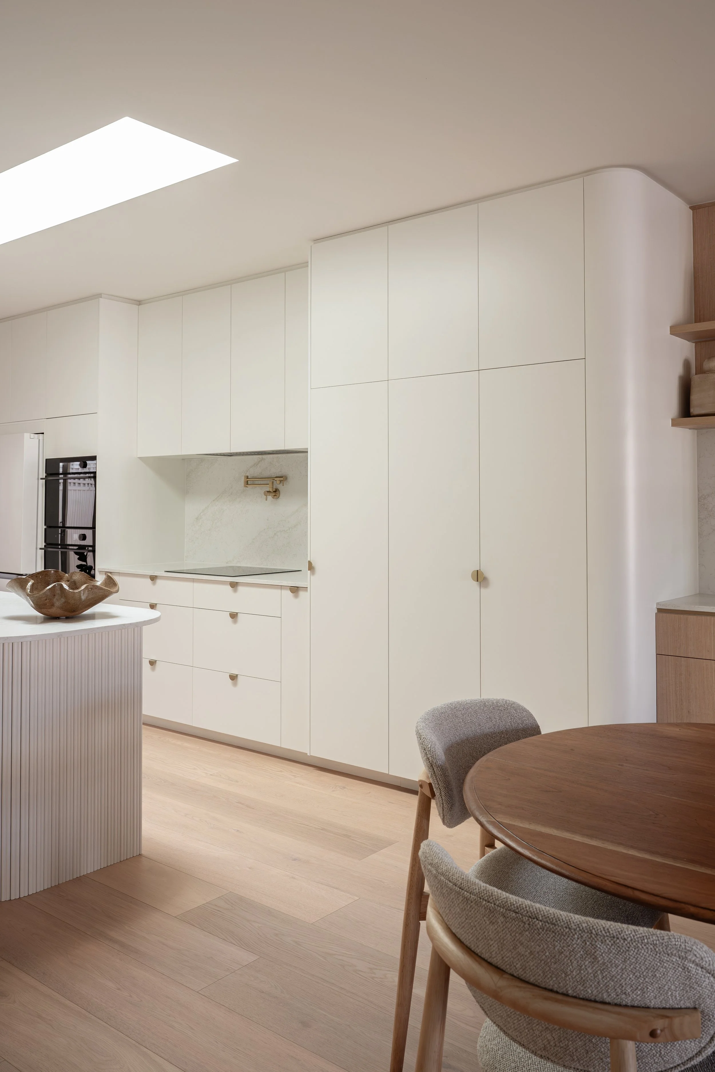 Classic white kitchen with brass handles. 